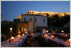 &#917;&#955;&#945;&#953;&#945; restaurant.  Rooftop dining area with the Acropolis (&#913;&#954;&#961;&#972;&#960;&#959;&#955;&#951;) behind it, at night.