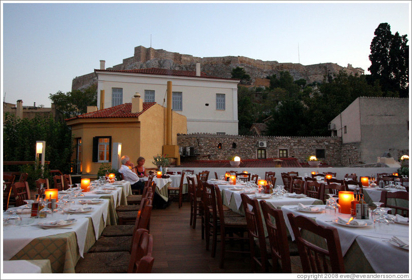 &#917;&#955;&#945;&#953;&#945; restaurant.  Rooftop dining area with the Acropolis (&#913;&#954;&#961;&#972;&#960;&#959;&#955;&#951;) behind it.