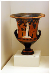 Calyx krater depicting a female figure adorning a herm with an altar in front of it and a nude man holding a spit for entrails from a sacrifice.  From 350-325 BC.  National Archaeological Museum.