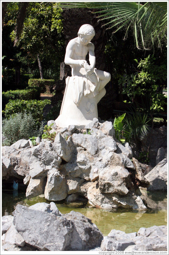 Statue overlooking a pond.  National Gardens.