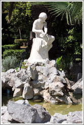 Statue overlooking a pond.  National Gardens.