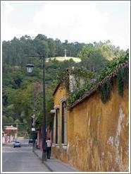 Antigua, Guatemala.  Steet; Cerro de la Cruz in the background.