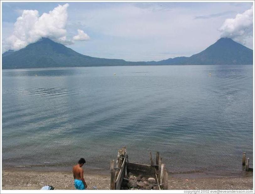 Swimmer in front of volcanoes Toliman and San Pedro.