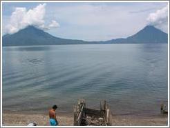 Swimmer in front of volcanoes Toliman and San Pedro.