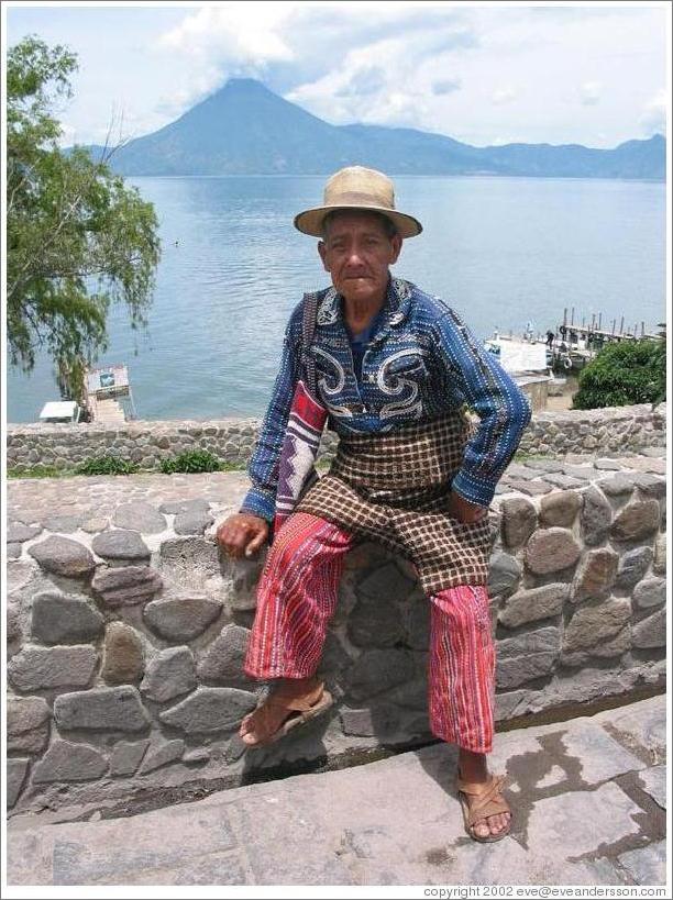 Man in traditional wear in Panajachel, in front of Lago de Atitl&aacute;n.
