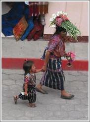 Woman with flowers on her head and girl, Panajachel.