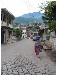 Woman balancing basket on heat, Santiago.