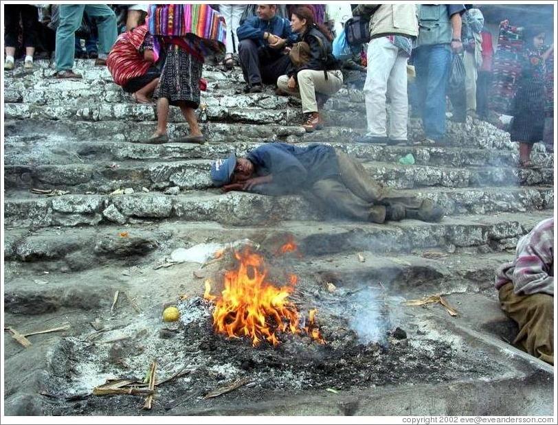 Man sleeping by fire.