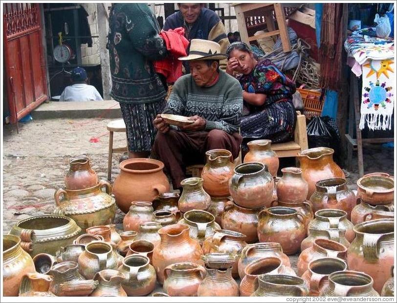 Woman and man selling pots.