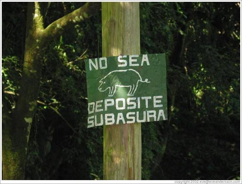 Sign: "Don't be a pig.  Throw away your garbage."  Lanqu&iacute;n caves.