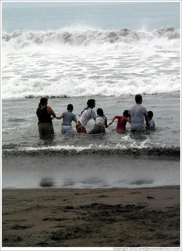 Monterrico beach.  Family enjoying the waves together.