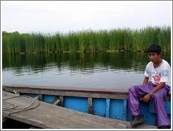 Boy and tall grasses, mangrove swamp.