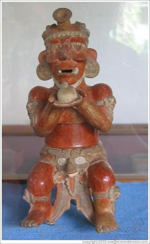 Tikal.  Figure holding offering, Ceramics Museum.
