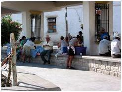 Parque Central.  Women washing, men sitting.