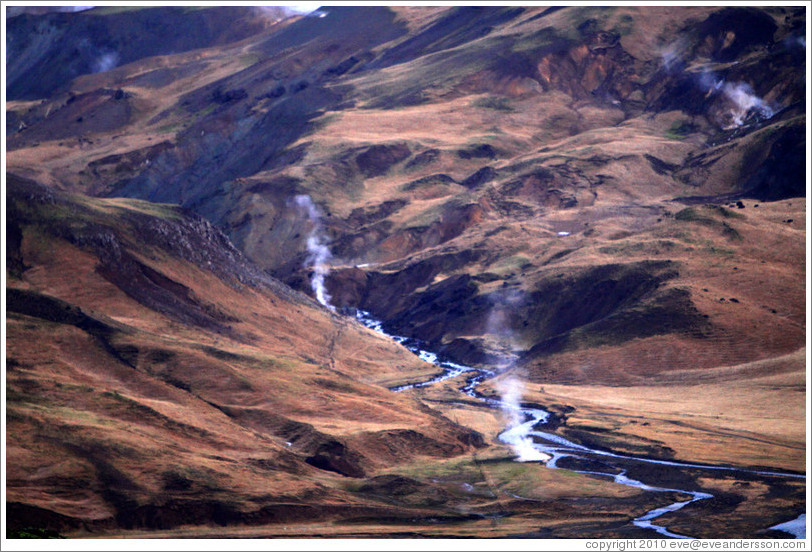 Geothermal steam rising from the ground.