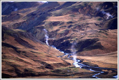 Geothermal steam rising from the ground.