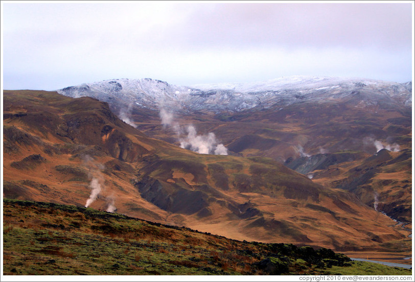 Geothermal steam rising from the ground.