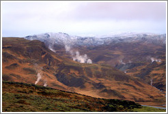 Geothermal steam rising from the ground.