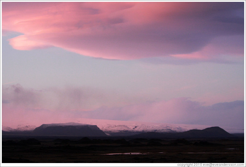 The glacier M?rdalsj?kull, appearing pink under a pink, dusky sky.