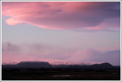 The glacier M?rdalsj?kull, appearing pink under a pink, dusky sky.