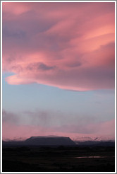 The glacier M?rdalsj?kull, appearing pink under a pink, dusky sky.