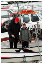 Father and child on boat in Reykjavik's harbor.