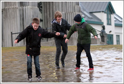 Children sliding on ice.