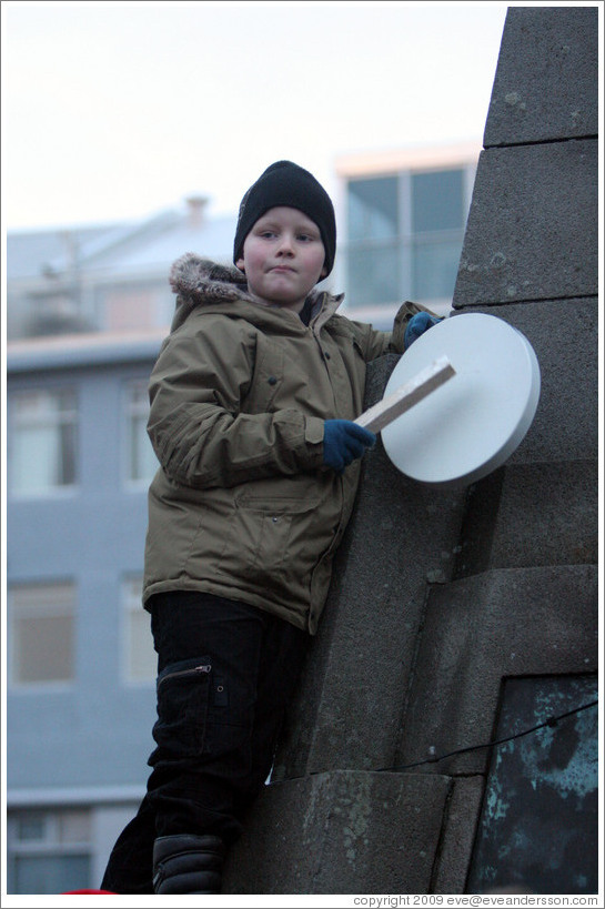 Reykjavik protest. Boy banging drum.