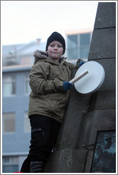 Reykjavik protest. Boy banging drum.