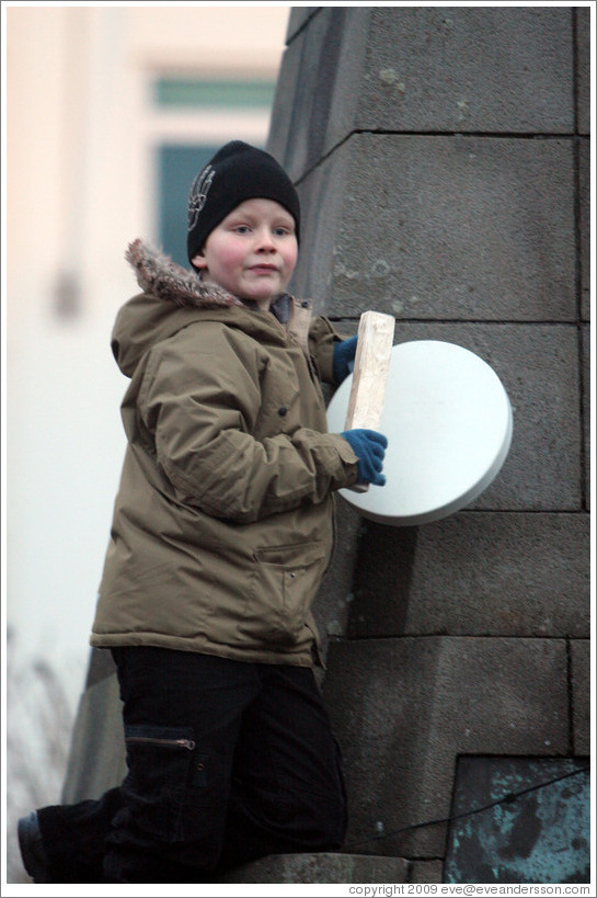 Reykjavik protest. Boy banging drum.