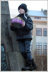 Reykjavik protest. Boy shaking tin.
