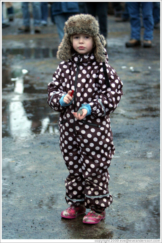 Girl in polka dotted outfit at Reykjavik protest.