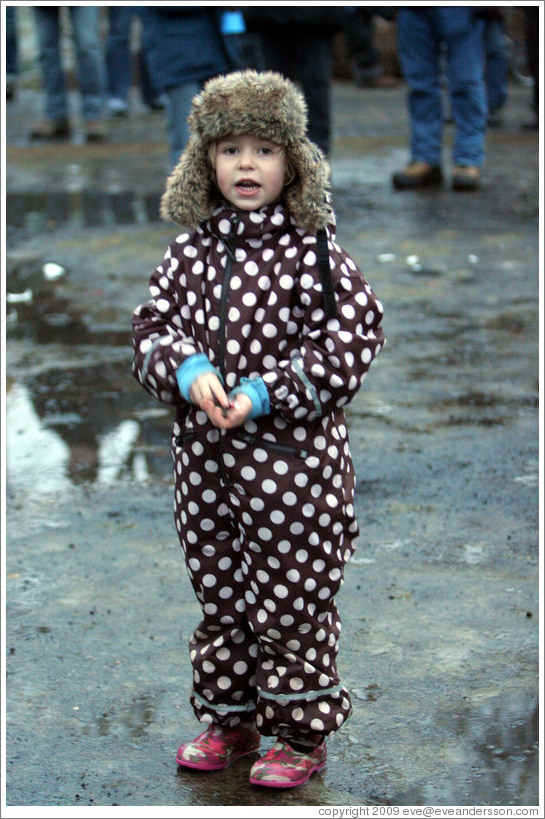 Girl in polka dotted outfit at Reykjavik protest.