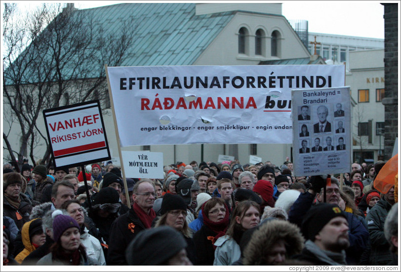 Reykjavik protest.  The wide sign says "Eftirlaunaforr?indi r?manna burt; engar blekkingar; engar smj?rkl?r; engin undanbr?g?"Away with pension privileges of officials; no deceptions; no pinches of butter [diversionary tactics]; no tricks.")  The sign on the left says "Vanh?r?sstj? ("Unfit  Government"). The sign on the right says "Bankaleynd = Brandari; ?tta er stj?Kaup?ings sem strika?fir; skuldir upp ?3 milljar?r? ("ank Secrecy = A joke; This is the board of Kaupthing which erased debts amounting to 53 billion kronur").