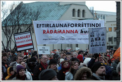 Reykjavik protest.  The wide sign says "Eftirlaunaforr?indi r?manna burt; engar blekkingar; engar smj?rkl?r; engin undanbr?g?"Away with pension privileges of officials; no deceptions; no pinches of butter [diversionary tactics]; no tricks.")  The sign on the left says "Vanh?r?sstj? ("Unfit  Government"). The sign on the right says "Bankaleynd = Brandari; ?tta er stj?Kaup?ings sem strika?fir; skuldir upp ?3 milljar?r? ("ank Secrecy = A joke; This is the board of Kaupthing which erased debts amounting to 53 billion kronur").