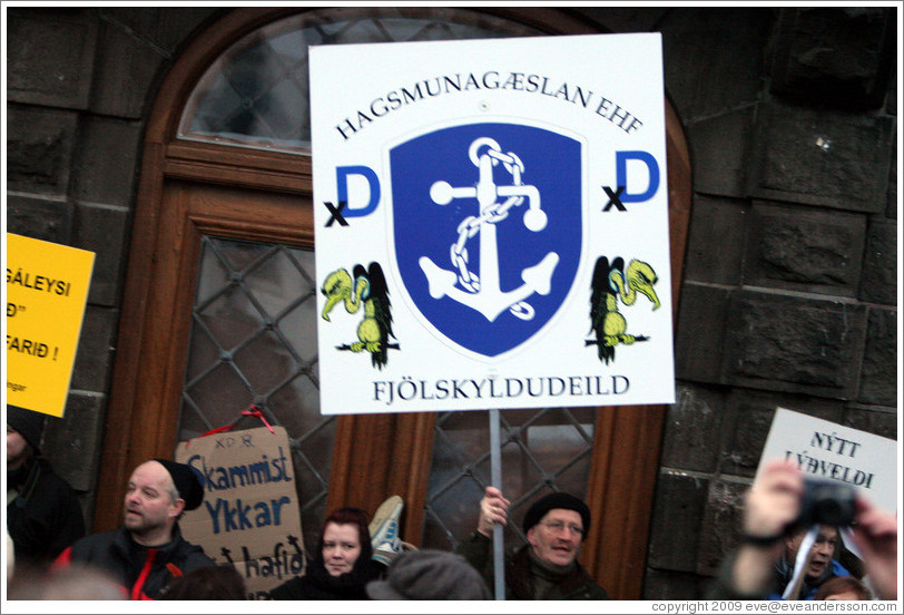 Reykjavik protest.  The sign says "Hagsmung?an EHF Fj?lskyldudeild" ("Special Interests Guardians Ltd., Family department.").