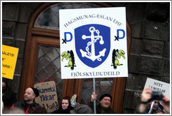 Reykjavik protest.  The sign says "Hagsmung?an EHF Fj?lskyldudeild" ("Special Interests Guardians Ltd., Family department.").