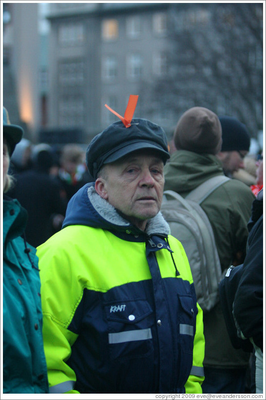 Reykjavik protest.  Man with orange ribbon signifying peaceful protest.