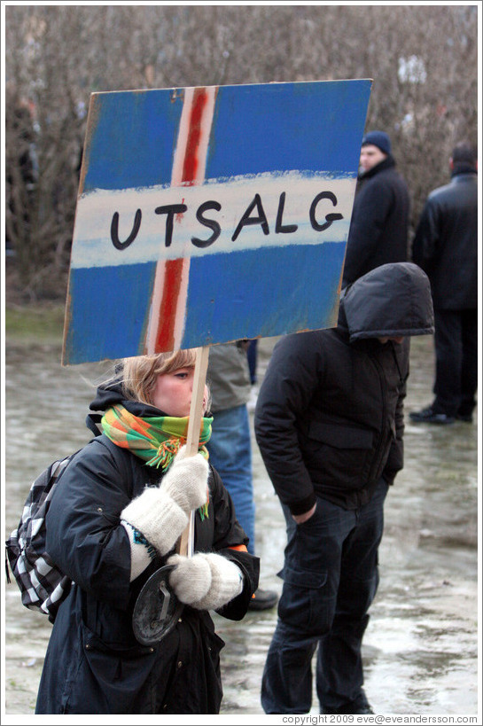 Reykjavik protest.  The sign depicts an Icelandic flag with "UTSALG" (the Norwegian word for "SALE") on it, implying Iceland is for sale.
