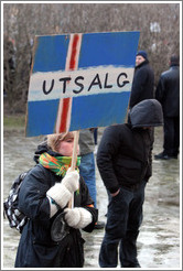 Reykjavik protest.  The sign depicts an Icelandic flag with "UTSALG" (the Norwegian word for "SALE") on it, implying Iceland is for sale.