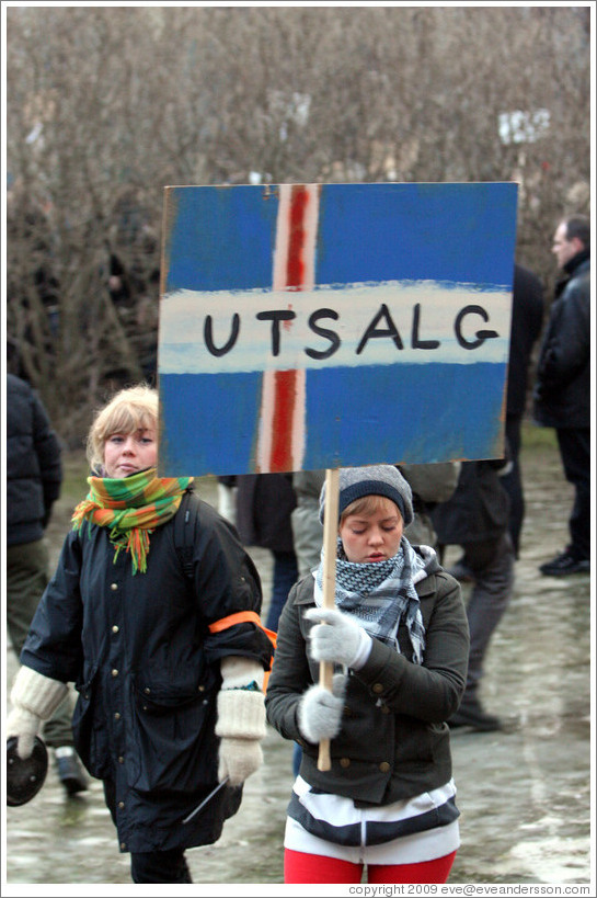 Reykjavik protest.  The sign depicts an Icelandic flag with "UTSALG" (the Norwegian word for "SALE") on it, implying Iceland is for sale.