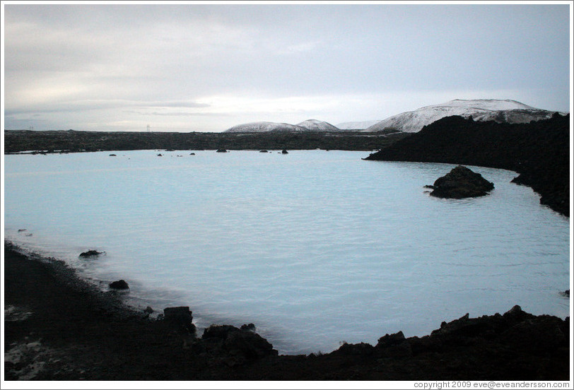 Volcanic terrain and water containing silica sediment near the Blue Lagoon.