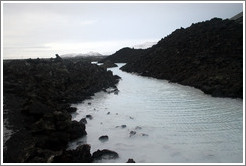 Volcanic terrain and water containing silica sediment near the Blue Lagoon.

