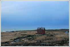 Red house on Iceland's volcanic coast.