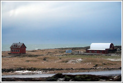 Red house and building on Iceland's volcanic coast.