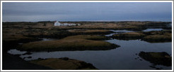 White house on Iceland's volcanic coast.