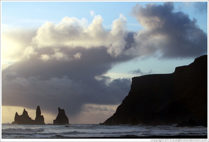 Reynisdrangar, volcanic rock shooting from the ocean, under the mountain Reynisfjall. 