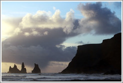 Reynisdrangar, volcanic rock shooting from the ocean, under the mountain Reynisfjall. 