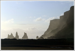 Reynisdrangar, volcanic rock shooting from the ocean, under the mountain Reynisfjall. 