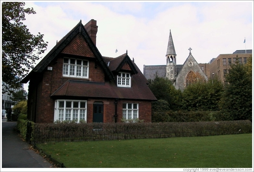 A cottage in Stephen's Green. Behind it is an old, beautiful church.